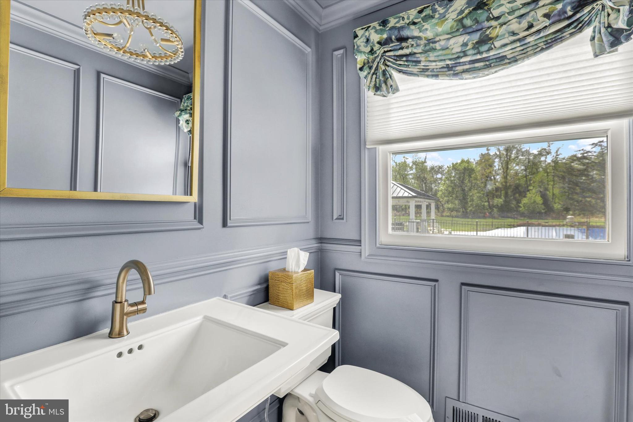 1071 Highland Road Newtown, PA 18940 - Photo 22 of 40 a bathroom with a toilet sink and mirror