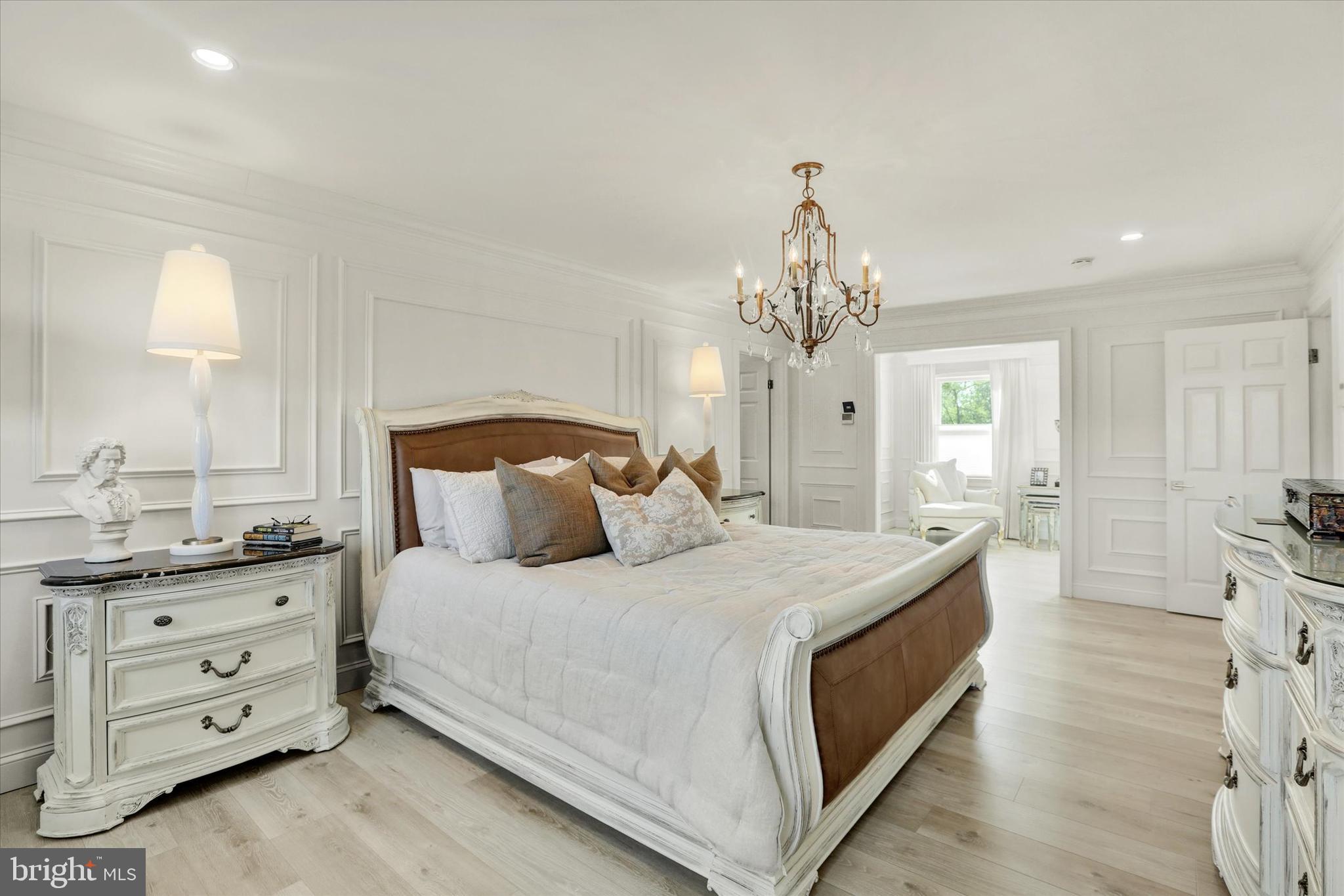 1071 Highland Road Newtown, PA 18940 - Photo 24 of 40 a spacious bedroom with a bed and a chandelier