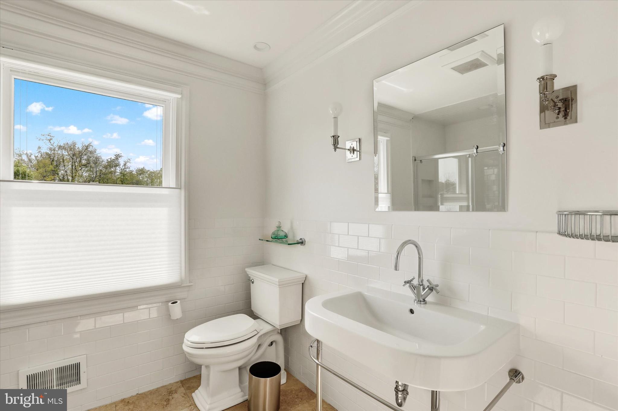 1071 Highland Road Newtown, PA 18940 - Photo 32 of 40 a bathroom with a toilet sink and mirror
