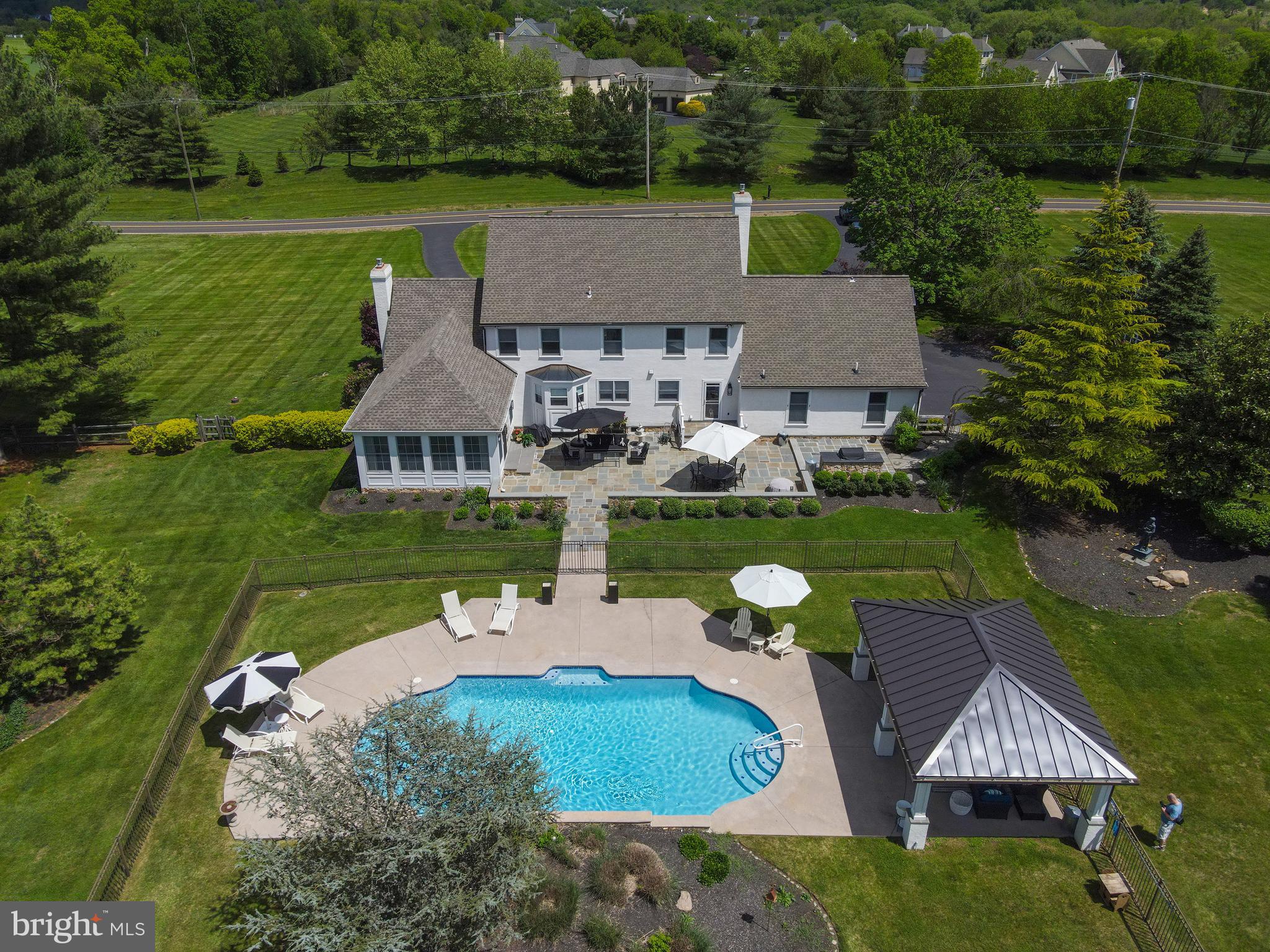 1071 Highland Road Newtown, PA 18940 - Photo 40 of 40 an aerial view of a house with swimming pool patio and lake view