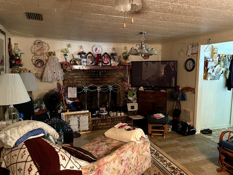 5161 Griffith Mill Road Holt, FL 32564 - Photo 19 of 25 a bed room with a bed a couch and a window