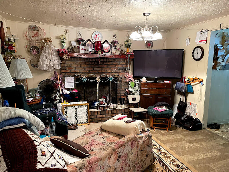 5161 Griffith Mill Road Holt, FL 32564 - Photo 21 of 25 a living room with furniture a flat screen tv and a fireplace