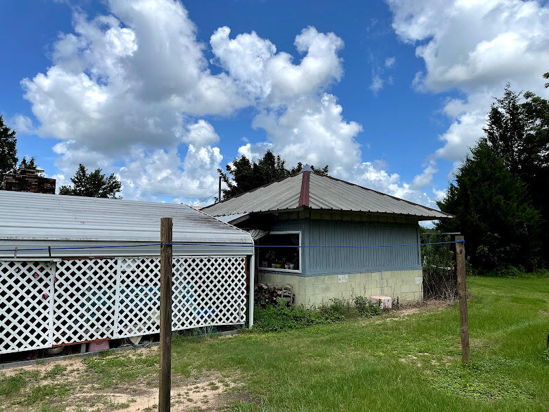 5161 Griffith Mill Road Holt, FL 32564 - Photo 7 of 25 a front view of a house with a garden