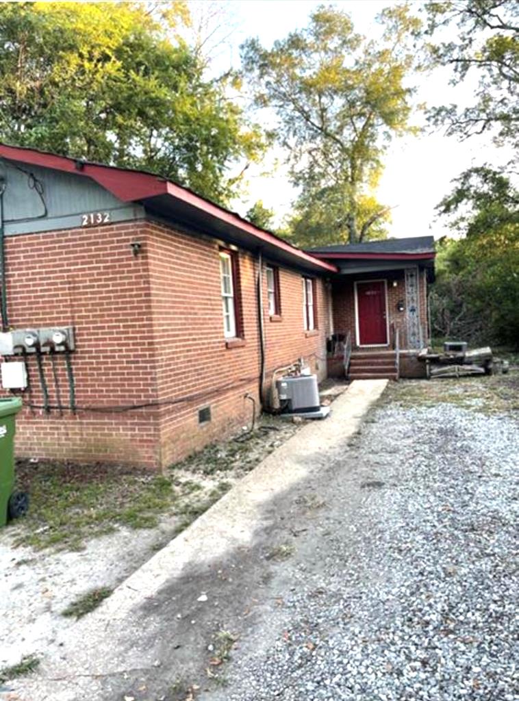 2132 Tillman Street Columbus, GA 31906 - Photo 1 of 3 a backyard of a house with yard and outdoor seating