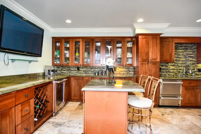 a living room with fireplace furniture and a large window