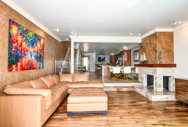 a living room with furniture a fireplace and a flat screen tv