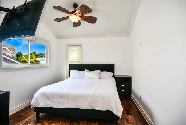 a hallway with a wooden floor and cabinets