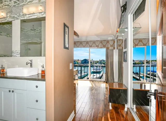 a bath room with a toilet a sink and a large mirror