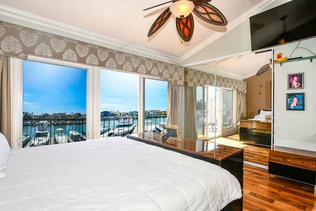 a room with wooden floor and windows