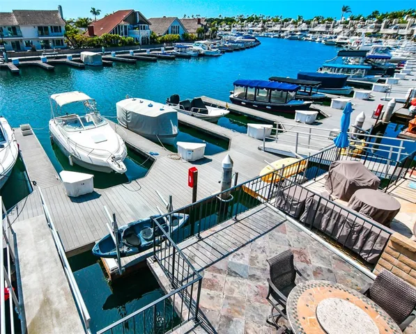 a balcony with wooden floor and outdoor seating