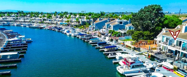 an aerial view of residential houses with outdoor space and swimming pool