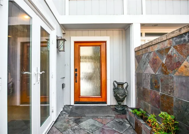 a kitchen with stainless steel appliances kitchen island granite countertop wooden cabinets a dining table and chairs