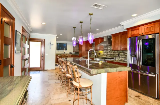 a kitchen with stainless steel appliances a sink stove and cabinets