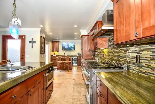 a view of a living room with kitchen appliances