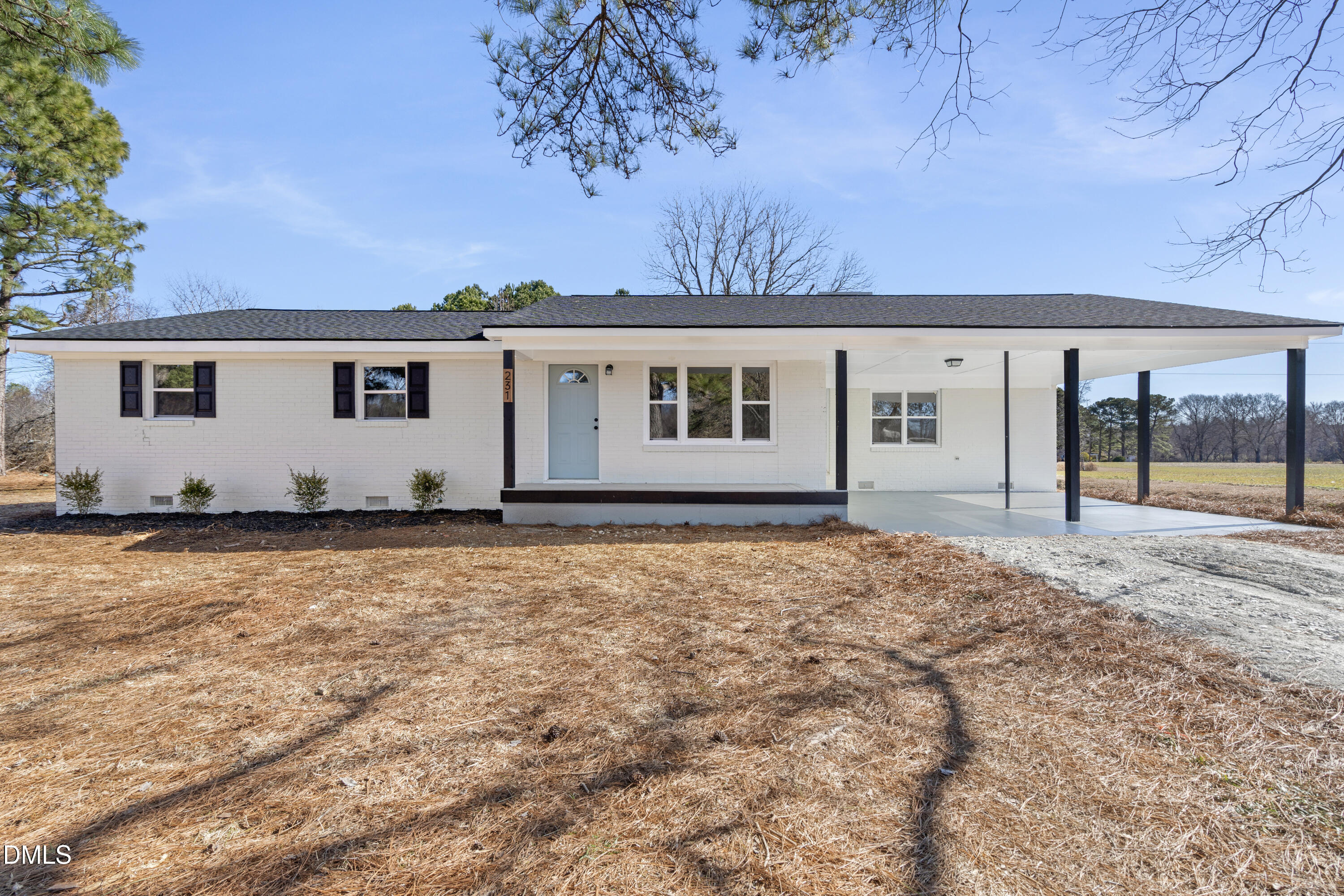 a view of house with yard and sitting area