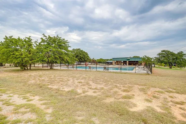 a view of swimming pool with outdoor seating and lake view