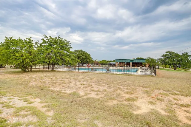 a view of swimming pool with outdoor seating and lake view
