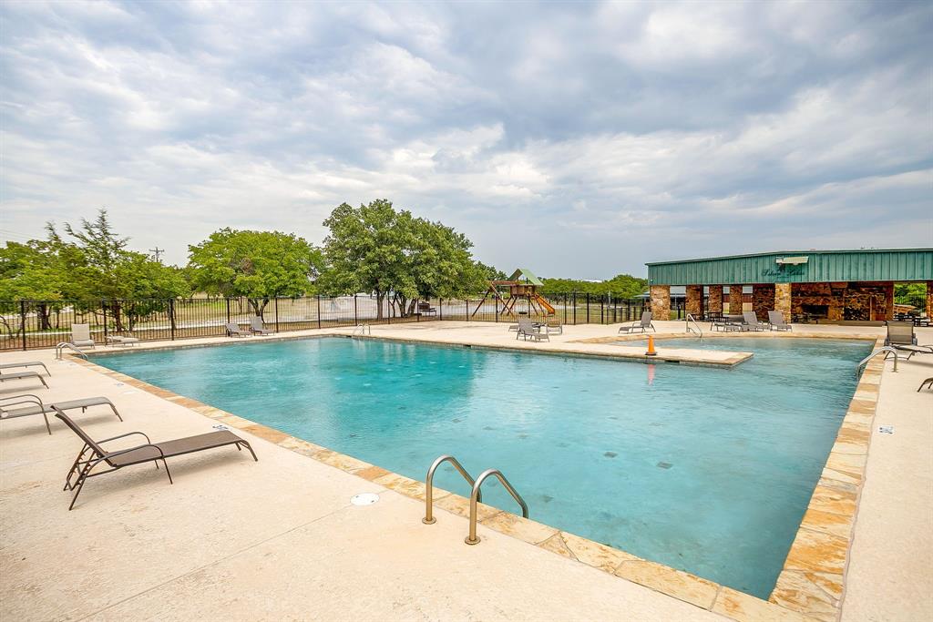205 Pheasant Run Court Sunset, TX 76270 - Photo 13 of 28 a view of swimming pool with outdoor seating and lake view