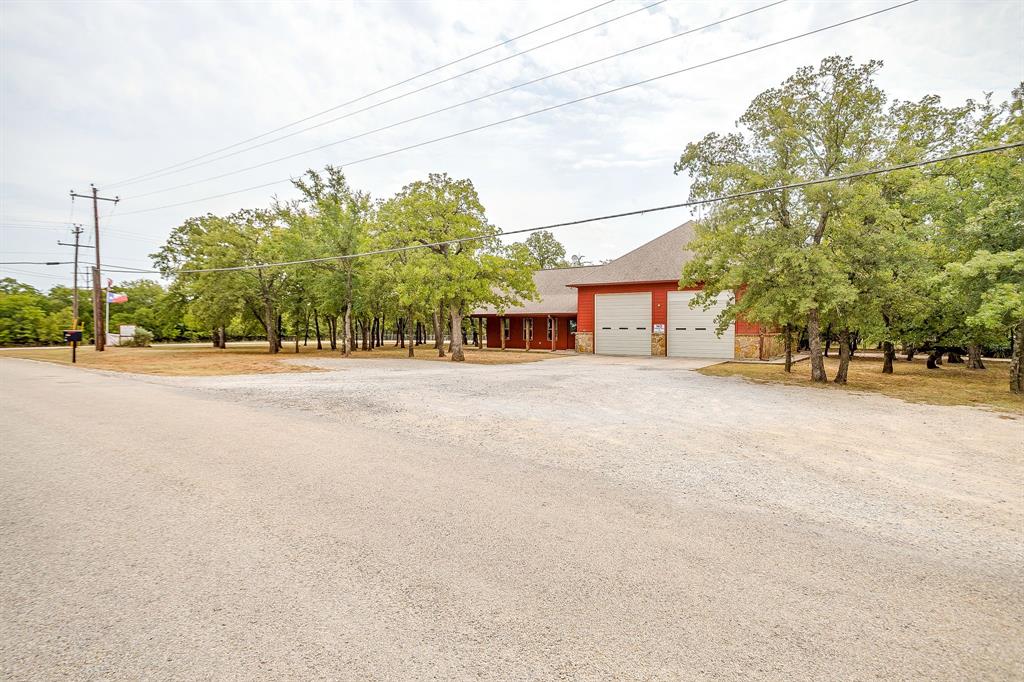 205 Pheasant Run Court Sunset, TX 76270 - Photo 10 of 28 a road view with large trees