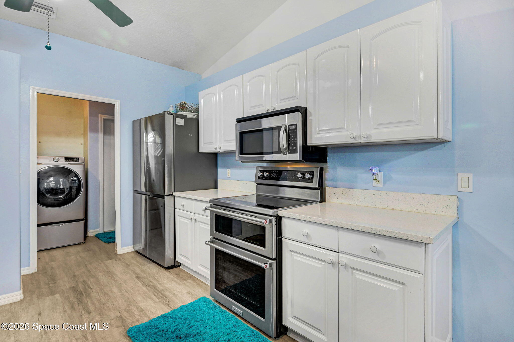 7155 Export Avenue Cocoa, FL 32927 - Photo 13 of 31 a kitchen with stainless steel appliances granite countertop a refrigerator stove and white cabinets
