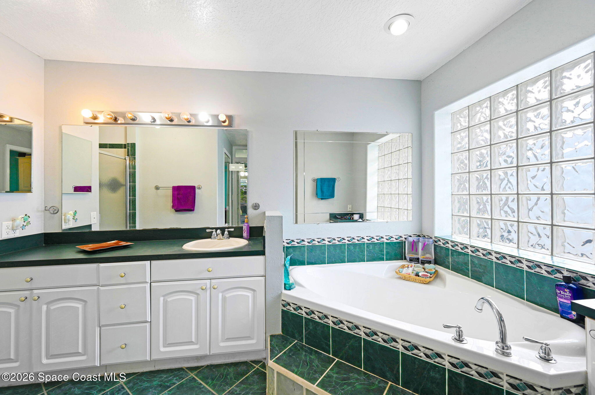 7155 Export Avenue Cocoa, FL 32927 - Photo 16 of 31 a bathroom with a granite countertop tub and a sink