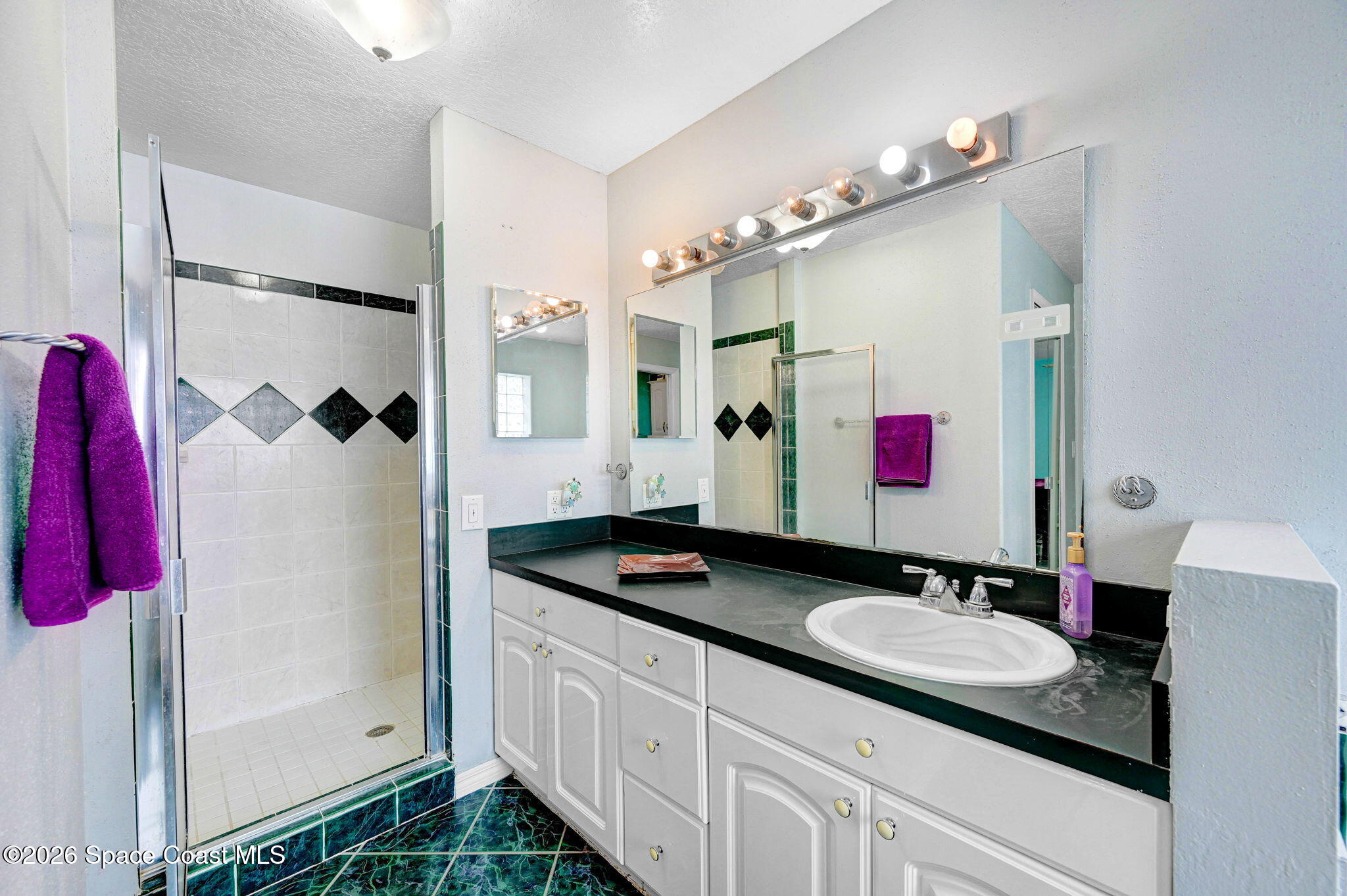 7155 Export Avenue Cocoa, FL 32927 - Photo 17 of 31 a bathroom with a granite countertop sink a shower and a mirror