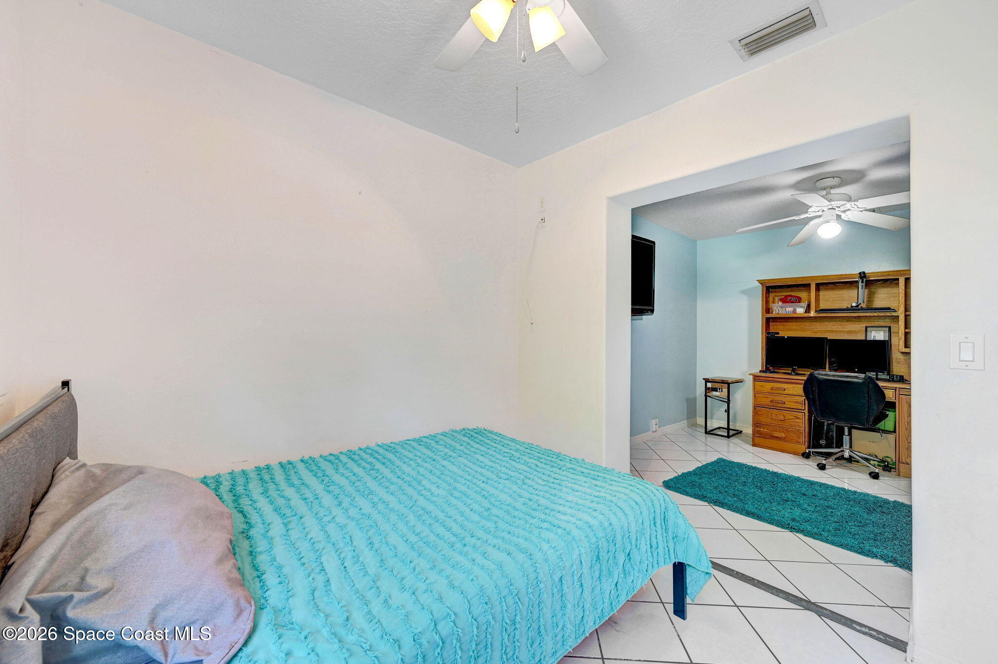 7155 Export Avenue Cocoa, FL 32927 - Photo 21 of 31 a bedroom with a bed and a chandelier