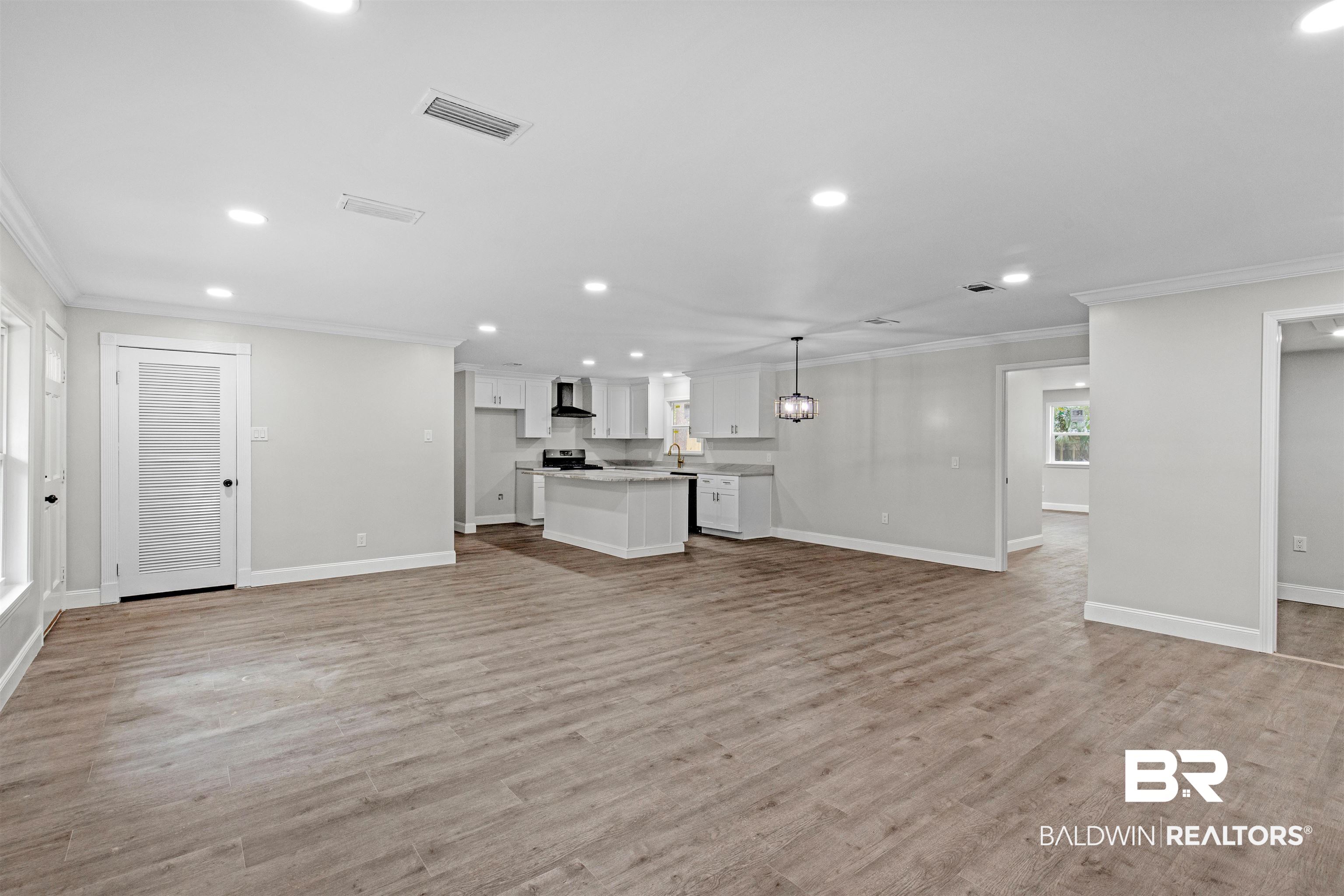 1432 South Polaris Drive Mobile, AL 36693 - Photo 2 of 27 Unfurnished living room featuring recessed lighting, ornamental molding, and light wood finished floors