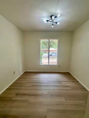 a bathroom with a granite countertop sink a toilet and a mirror