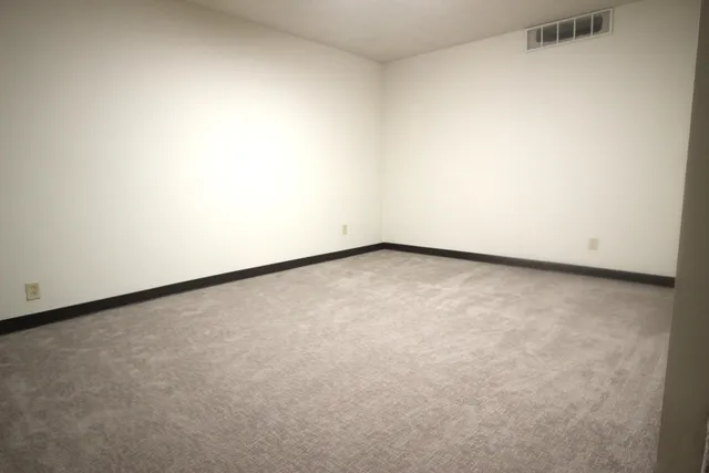 a view of a livingroom with a ceiling fan and window