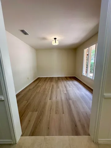 a view of kitchen with kitchen island and stainless steel appliances