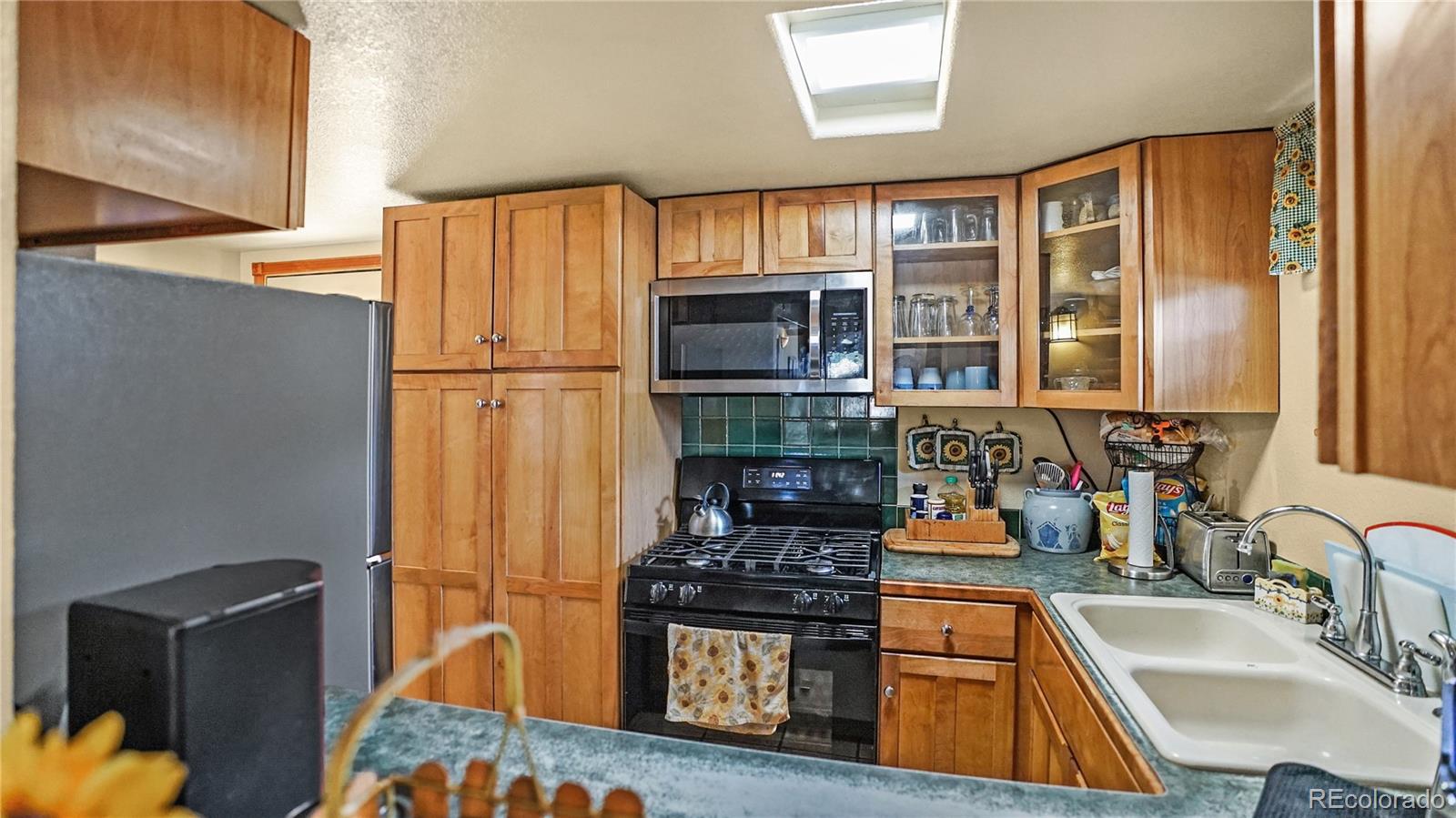 39 Cowan Road Bailey, CO 80421 - Photo 2 of 24 a kitchen with stainless steel appliances granite countertop a refrigerator stove and sink