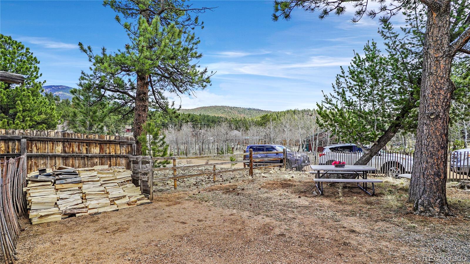 39 Cowan Road Bailey, CO 80421 - Photo 22 of 24 a view of a chair and table in the backyard