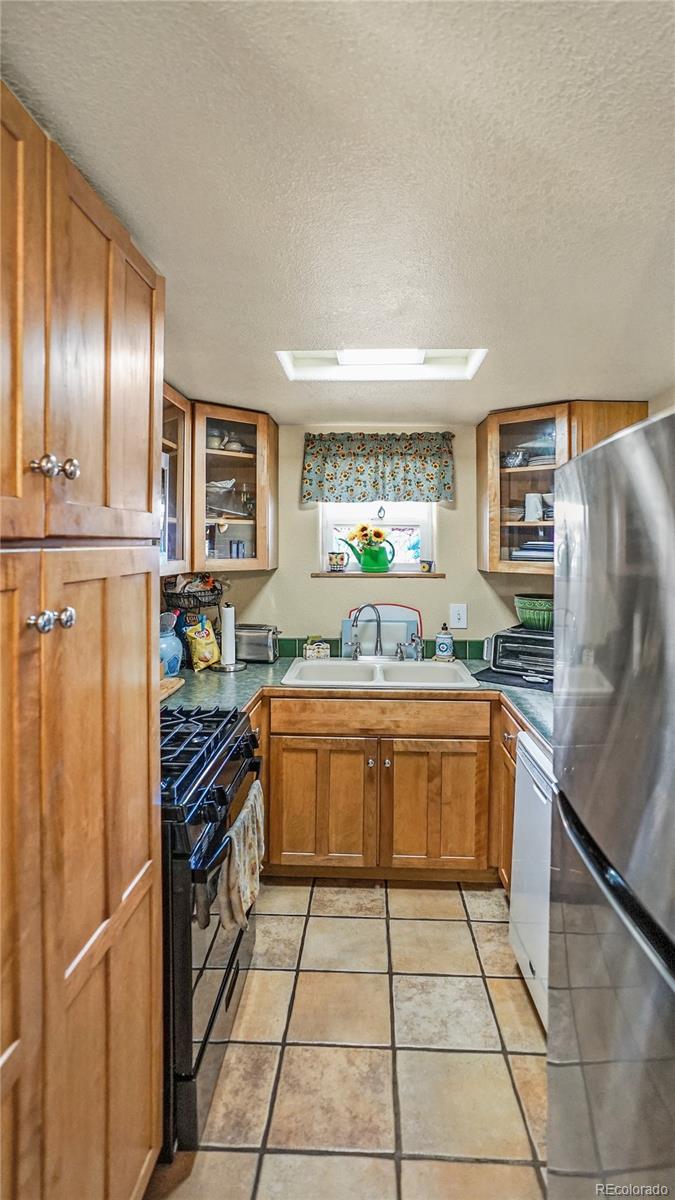 39 Cowan Road Bailey, CO 80421 - Photo 3 of 24 a large kitchen with stainless steel appliances granite countertop a refrigerator and a sink