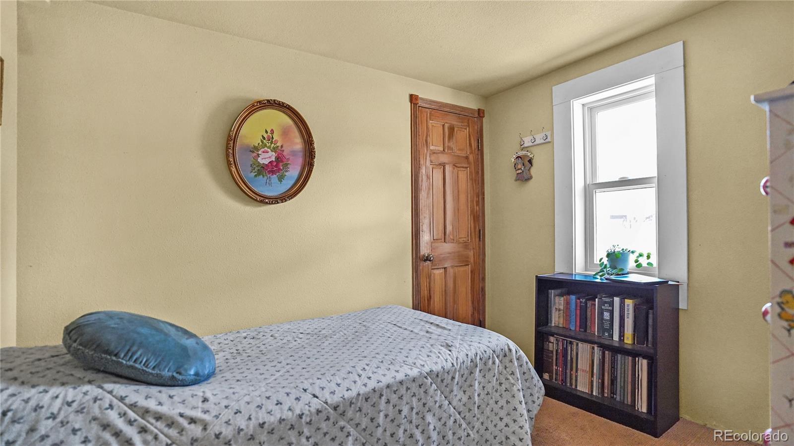 39 Cowan Road Bailey, CO 80421 - Photo 8 of 24 a bedroom with a bed and a window