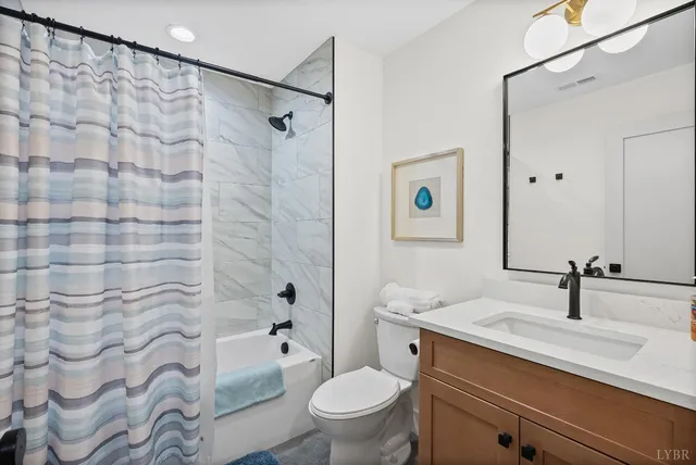 a bedroom with a bed and a flat tv screen on dresser