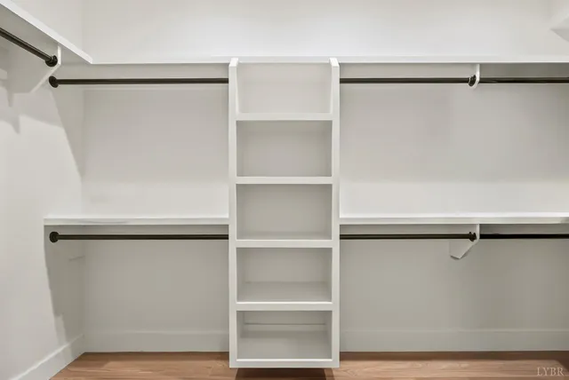 a living room with furniture a rug and a lamp