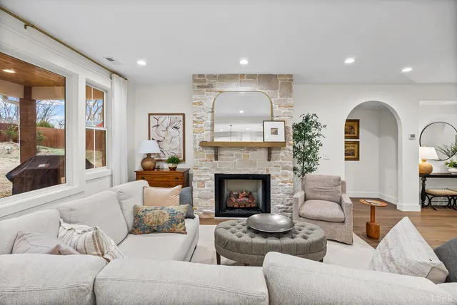 a living room with furniture and a fireplace
