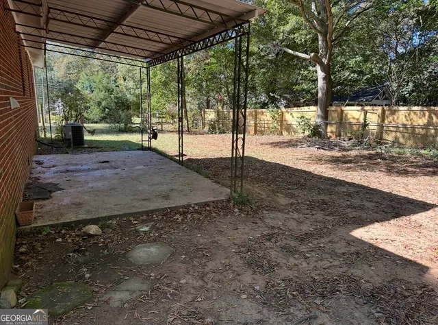 a view of a backyard with large tree