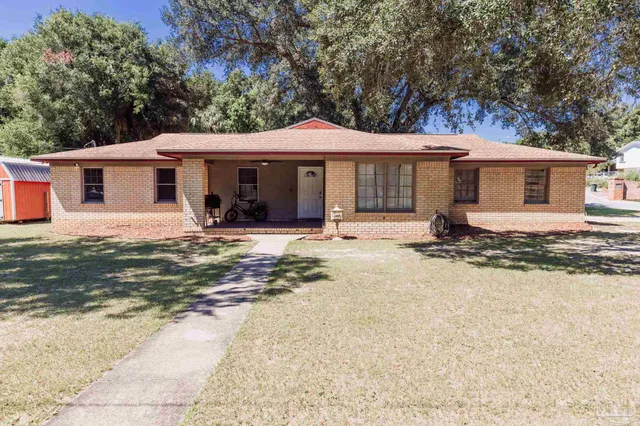 a backyard of a house with yard and tree s