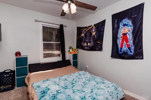 a bedroom with a bed and a painting on the wall