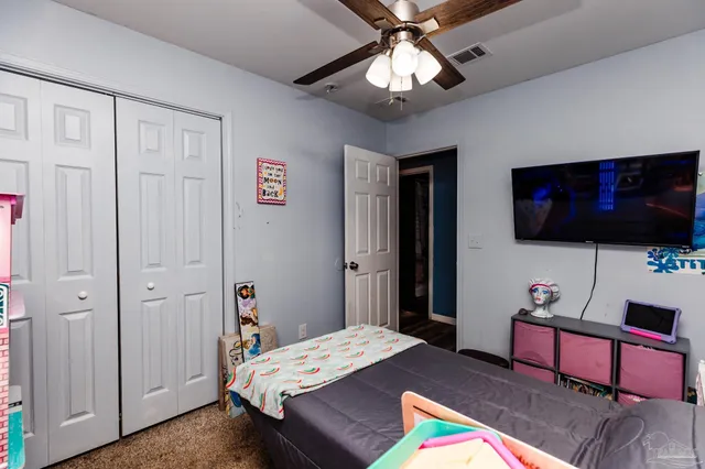 a bedroom with a bed and a flat screen tv
