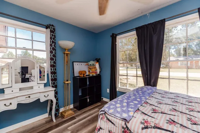 a bedroom with a bed and a large window with outer view