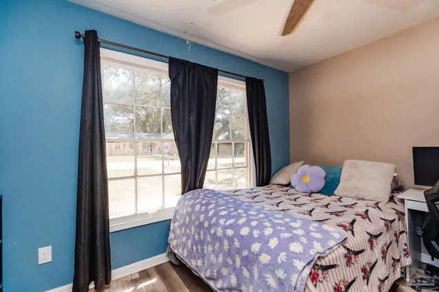 a bedroom with a bed and a window