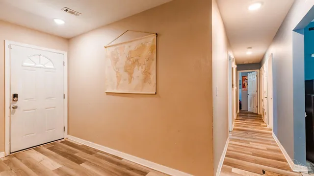 a view of a hallway with wooden floor