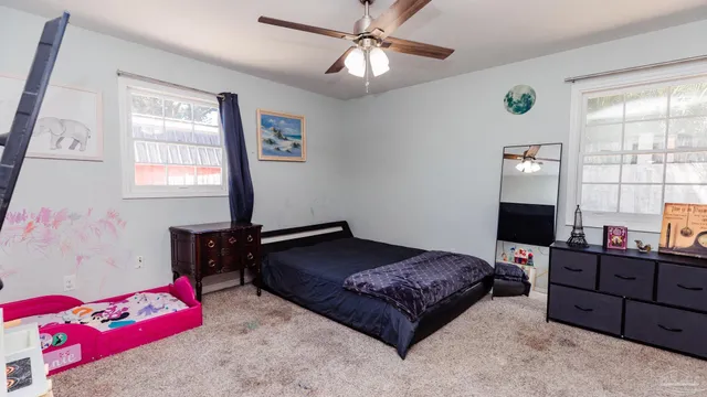 a bedroom with a bed and window