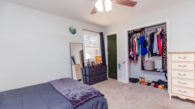 a bedroom with a bed and a walk in closet