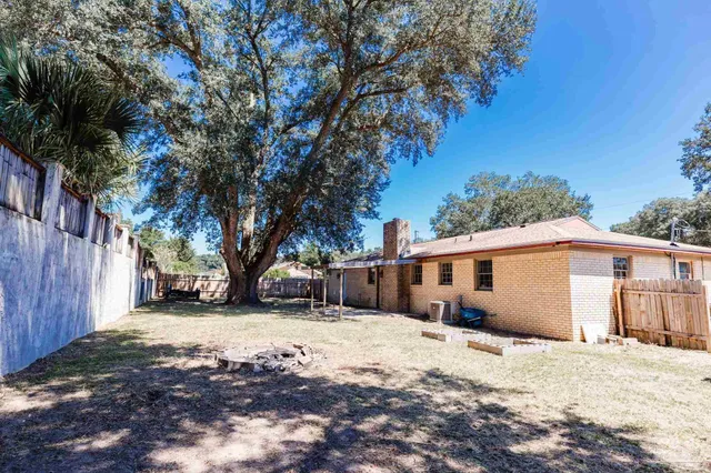 a view of a house with a yard covered with snow in front of house