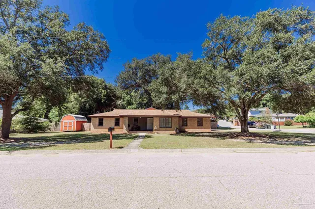 a view of a house with swimming pool and sitting area