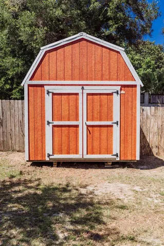 a view of backyard with small cabin